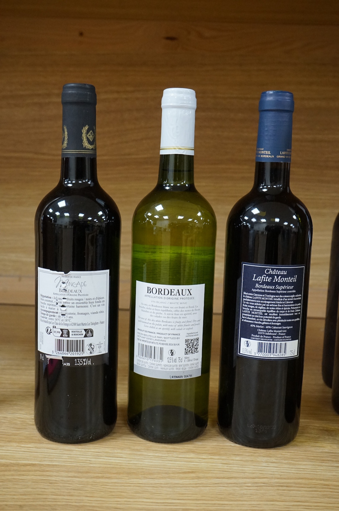 Six bottles of red and white wine to include Chablis Premier Cru 2001, Domaine Du Parc Muscadet 2003, Vin De Bordeaux, Chateau Lafite Monteil Bordeaux Supérieur 2020, Moncade Bordeaux and Buzet 1996. Condition - fair